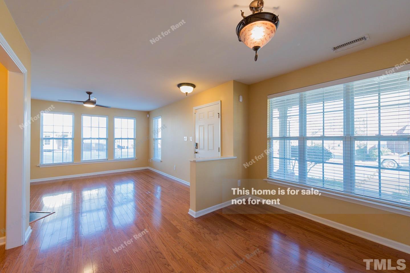 9801 Layla Avenue Raleigh, NC 27617 - Photo 9 of 17 a view of an empty room with window and wooden floor