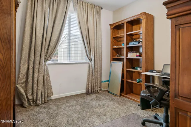 a bathroom with a granite countertop sink mirror vanity and toilet