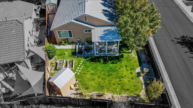 a view of a house with wooden fence and a yard