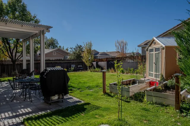 a view of a house with backyard and sitting area