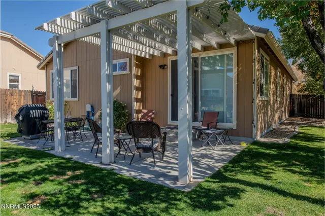 a front view of a house with garden and patio