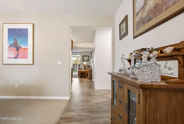 a view of a hallway with wooden floor and dining room