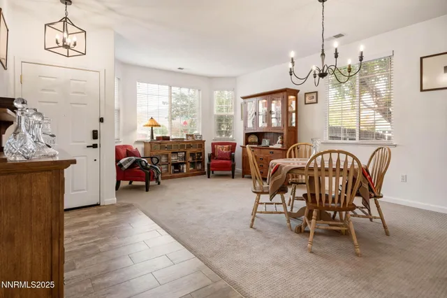 a view of a dining room with furniture and a chandelier