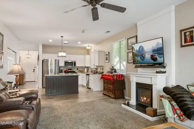 a kitchen with a refrigerator a microwave a sink and cabinets