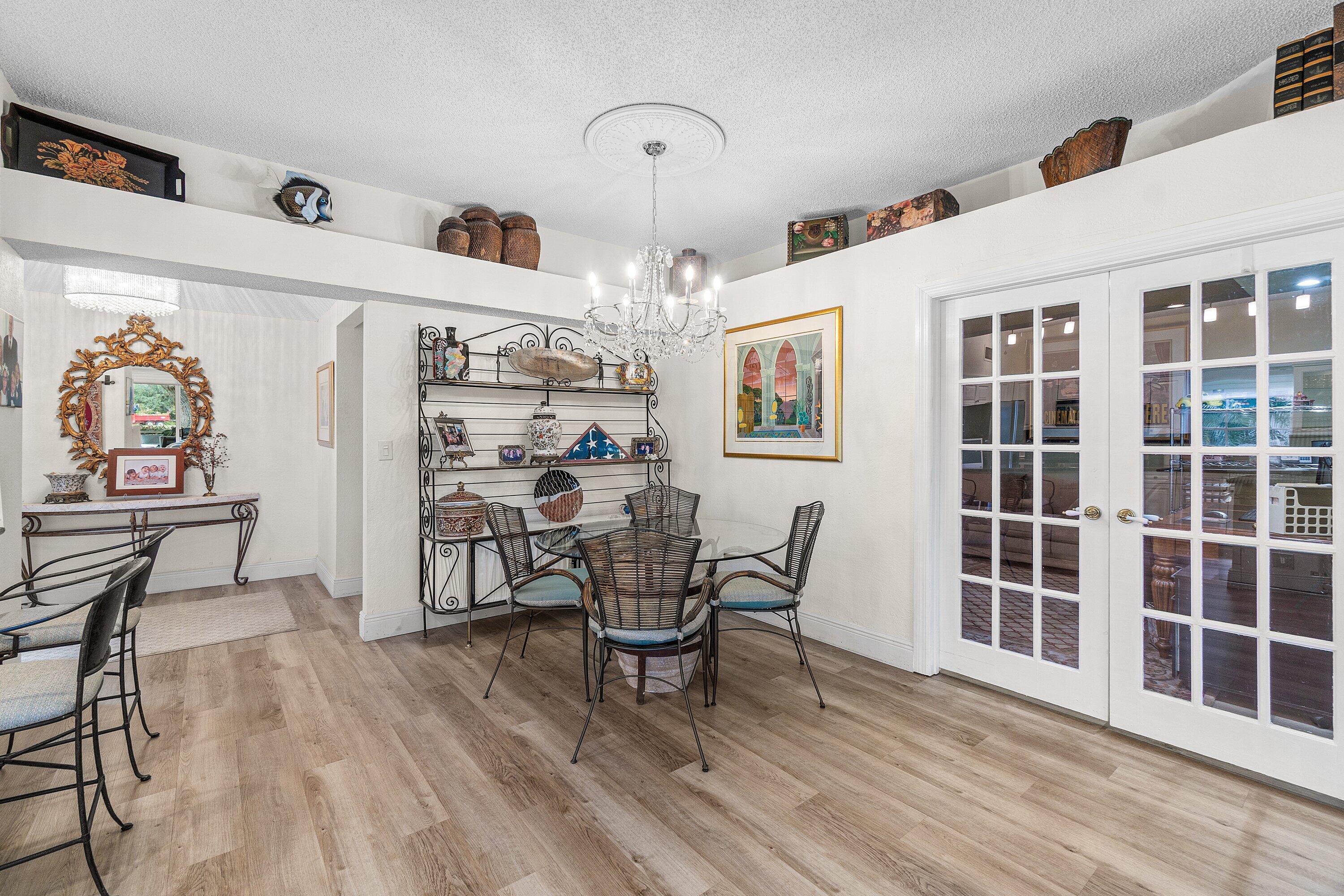 5100 Lake Catalina Drive, Unit C Boca Raton, FL 33496 - Photo 14 of 42 a view of a dining room with furniture and wooden floor