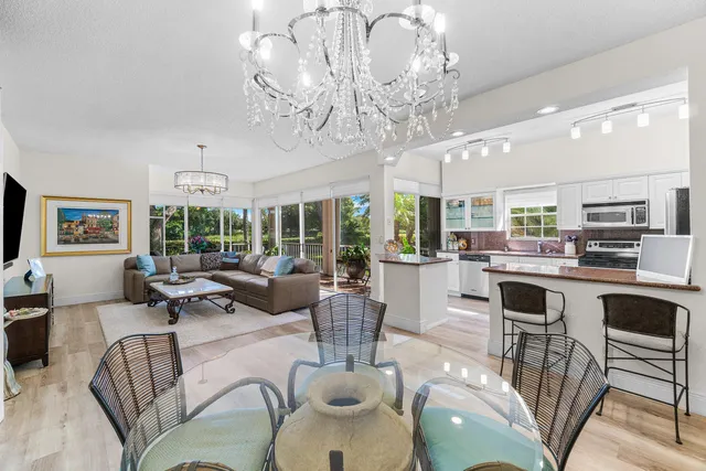 a living room with fireplace furniture and a chandelier