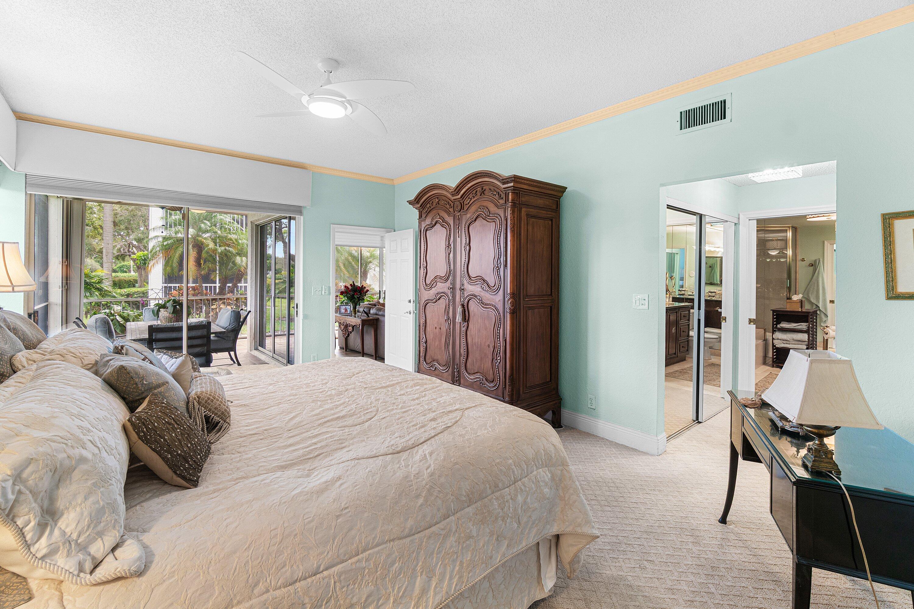 5100 Lake Catalina Drive, Unit C Boca Raton, FL 33496 - Photo 23 of 42 a bedroom with a bed and a large mirror