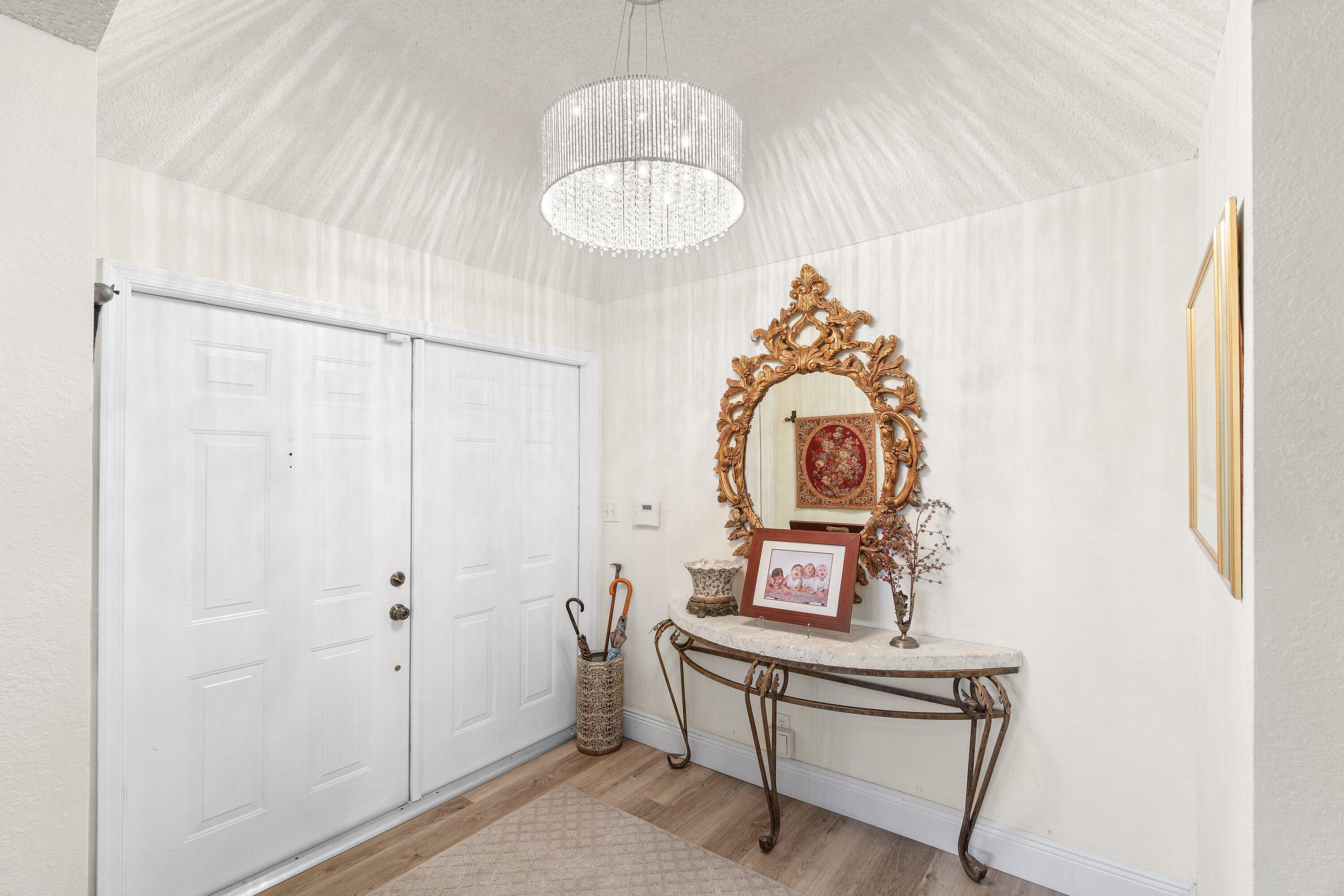 5100 Lake Catalina Drive, Unit C Boca Raton, FL 33496 - Photo 27 of 42 a room with a table and a mirror