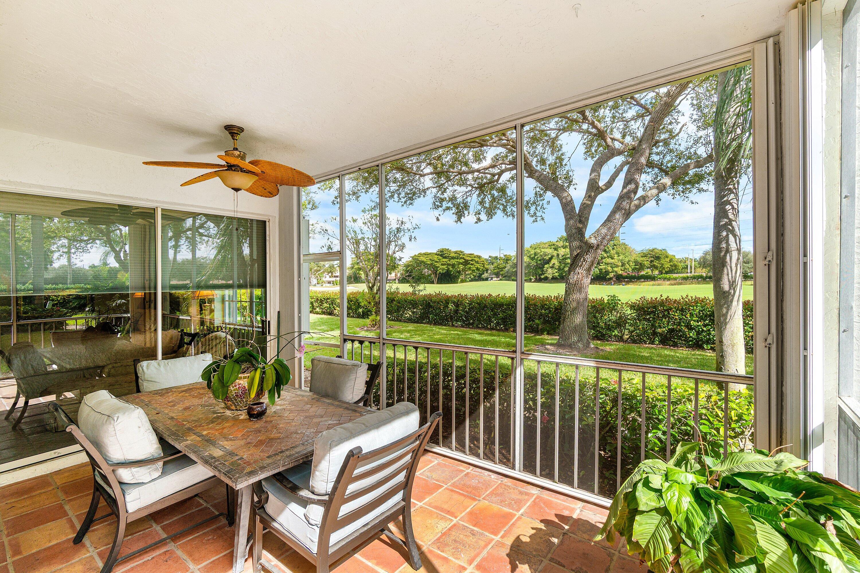 5100 Lake Catalina Drive, Unit C Boca Raton, FL 33496 - Photo 34 of 42 a view of a patio with a table chairs and a table
