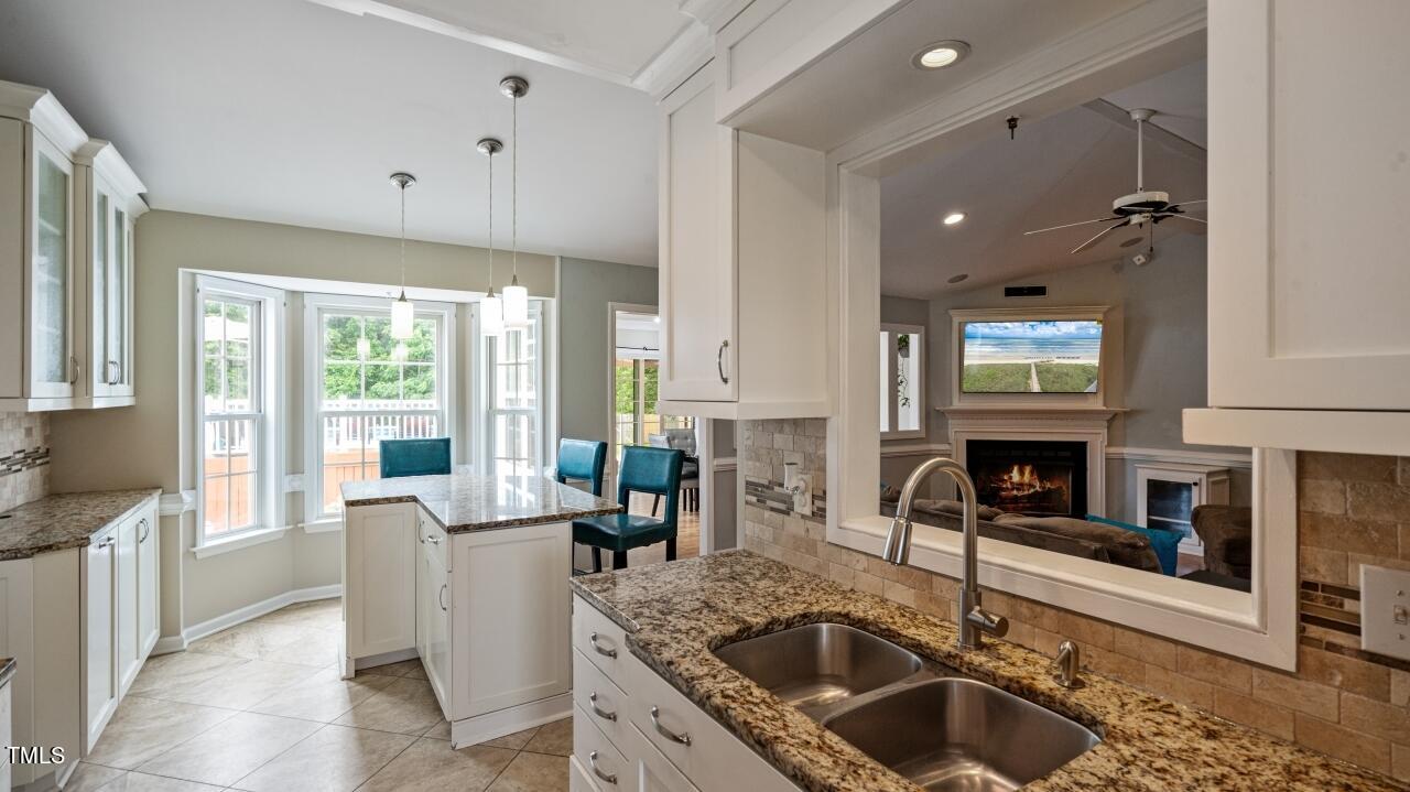 1065 Smith Road Smithfield, NC 27577 - Photo 14 of 36 a kitchen with granite countertop a sink stainless steel appliances and cabinets