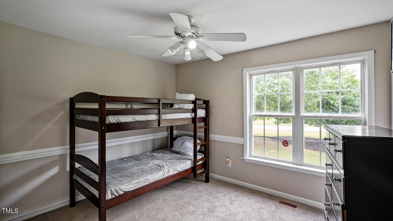 1065 Smith Road Smithfield, NC 27577 - Photo 20 of 36 a bedroom with a bed and a window