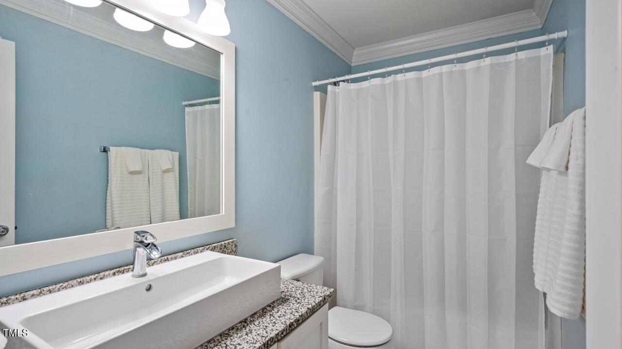 1065 Smith Road Smithfield, NC 27577 - Photo 22 of 36 a bathroom with a sink and a mirror