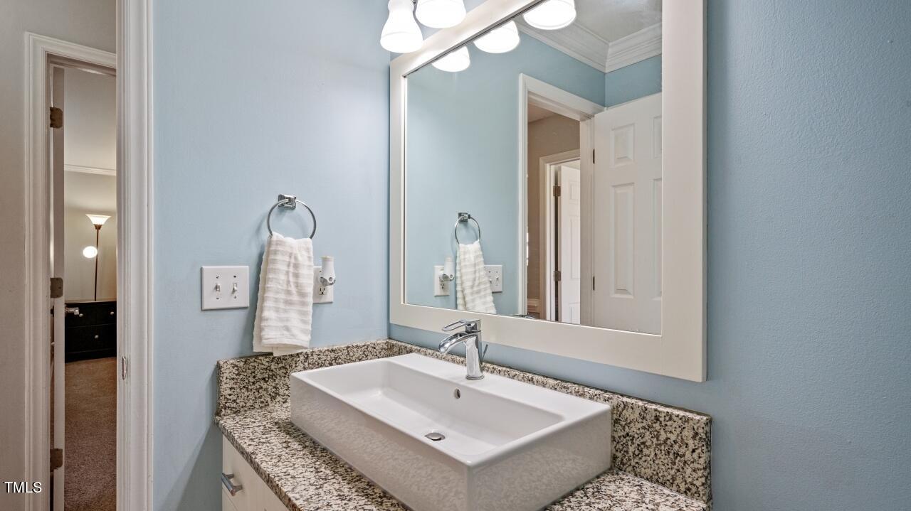 1065 Smith Road Smithfield, NC 27577 - Photo 23 of 36 a bathroom with a sink vanity and a mirror