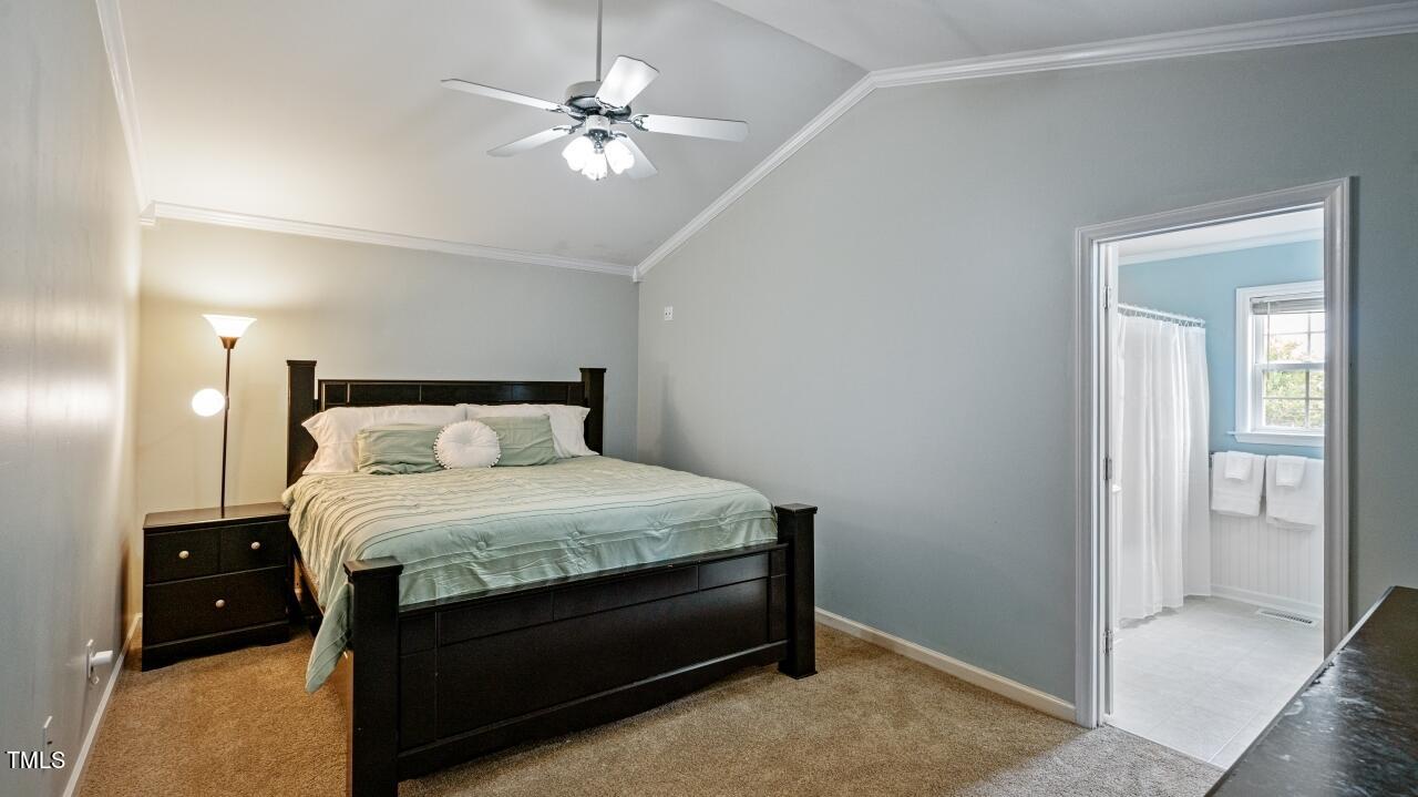 1065 Smith Road Smithfield, NC 27577 - Photo 25 of 36 a bedroom with a bed and a chandelier