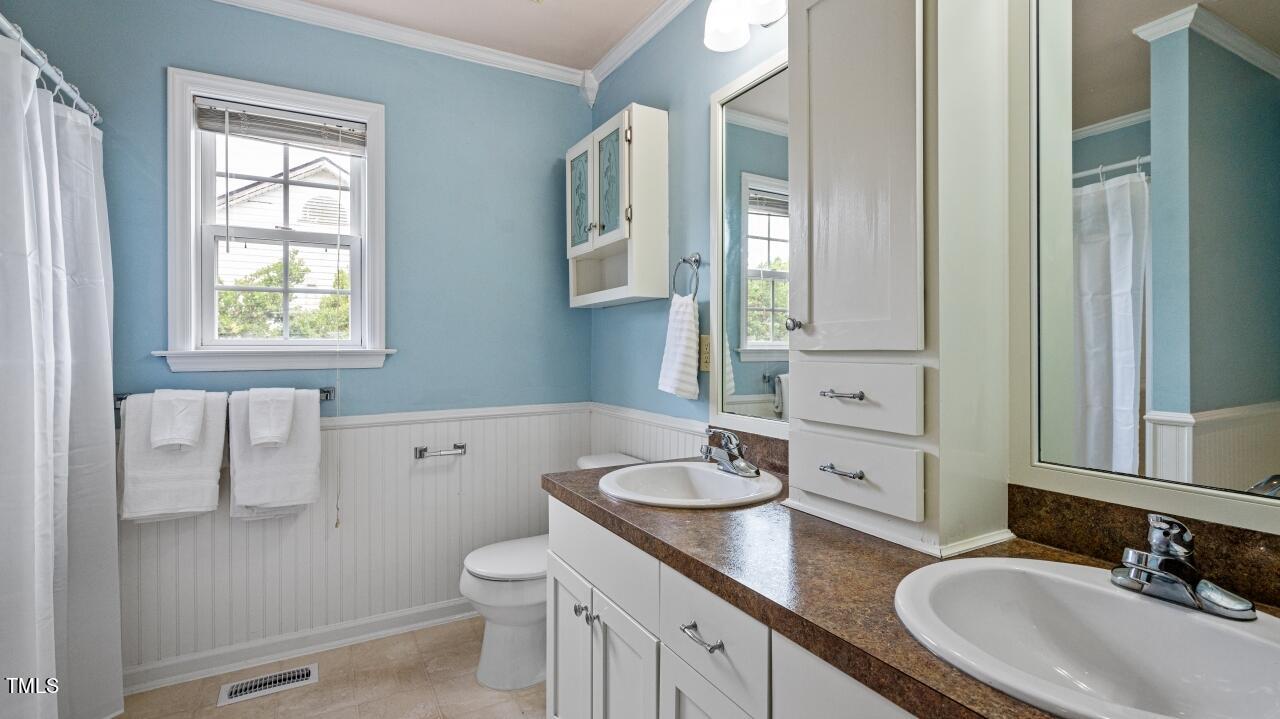 1065 Smith Road Smithfield, NC 27577 - Photo 26 of 36 a bathroom with a granite countertop sink toilet and mirror