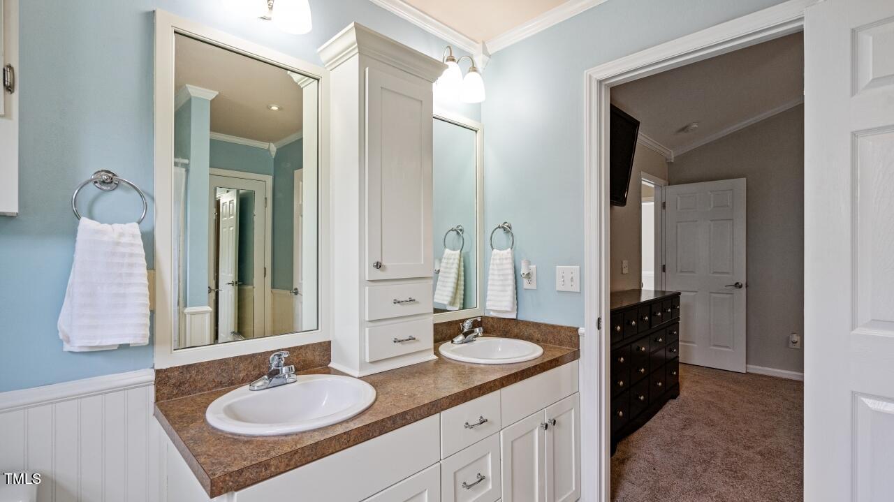 1065 Smith Road Smithfield, NC 27577 - Photo 27 of 36 a bathroom with a sink double vanity and a mirror