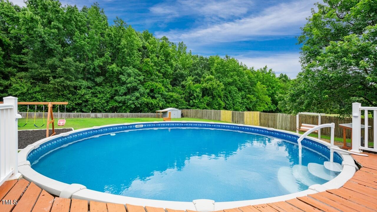 1065 Smith Road Smithfield, NC 27577 - Photo 33 of 36 a view of a swimming pool and trees in the background