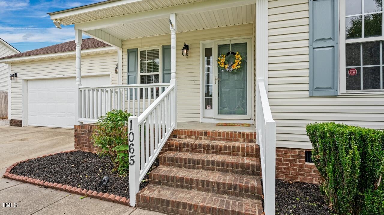 1065 Smith Road Smithfield, NC 27577 - Photo 6 of 36 a front view of a house with a garden