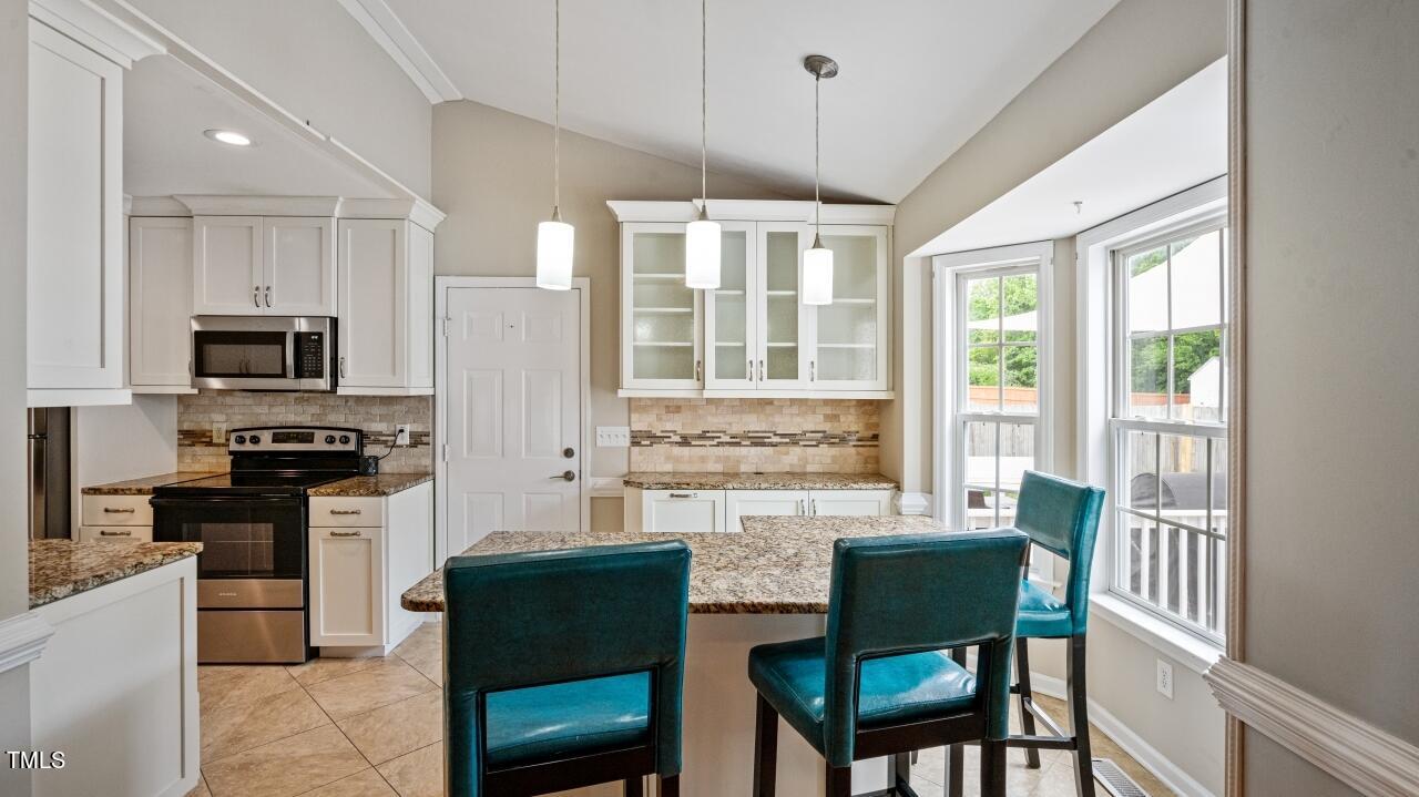 1065 Smith Road Smithfield, NC 27577 - Photo 10 of 36 a kitchen with a table chairs refrigerator and microwave