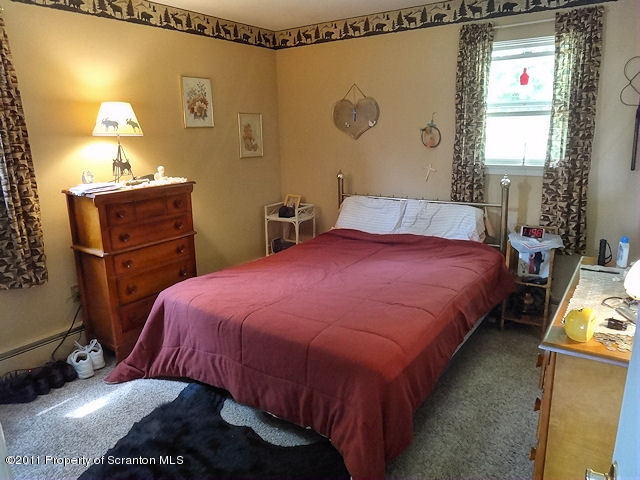 239 Fire Tower Road Mehoopany, PA 18629 - Photo 12 of 20 a bedroom with a bed and dresser with mirror