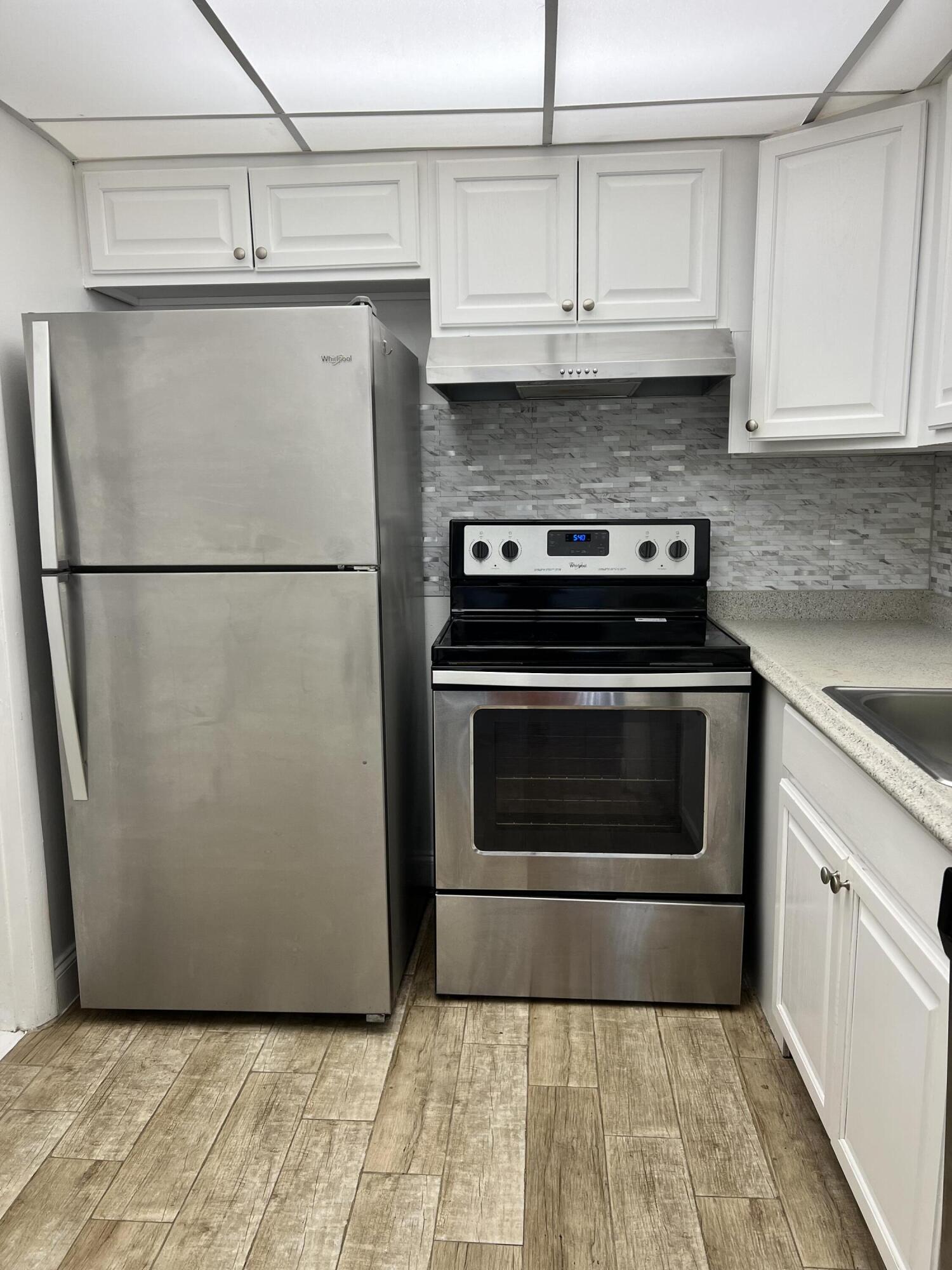 632 Northwest 13th Street, Unit 210 Boca Raton, FL 33486 - Photo 1 of 19 a stove top oven sitting inside of a kitchen
