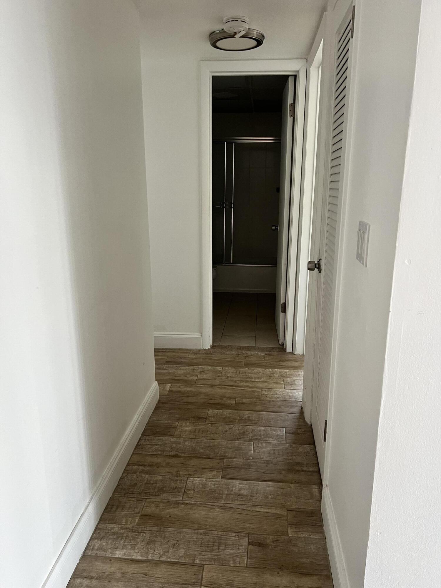 632 Northwest 13th Street, Unit 210 Boca Raton, FL 33486 - Photo 11 of 19 a view of a hallway with wooden floor