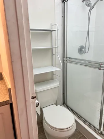 a bathroom with a granite countertop toilet