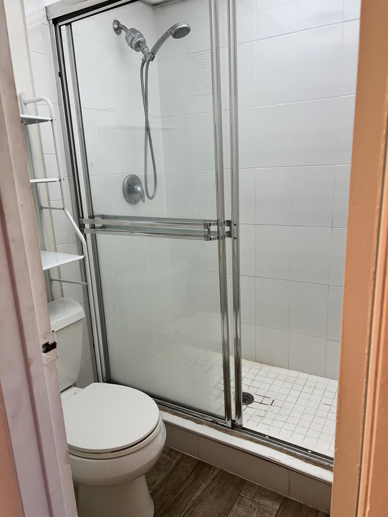 632 Northwest 13th Street, Unit 210 Boca Raton, FL 33486 - Photo 19 of 19 a bathroom with a granite countertop toilet