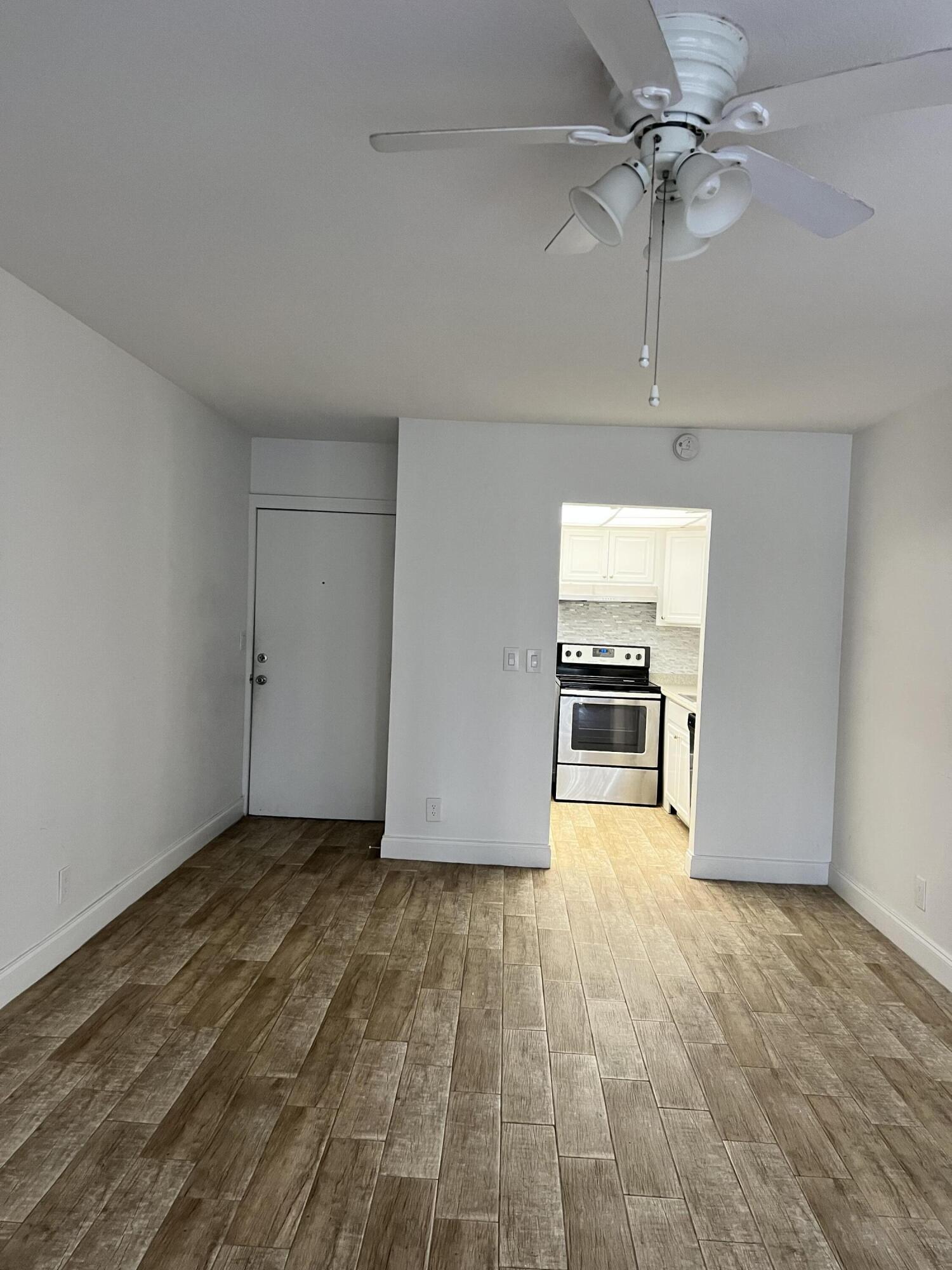 632 Northwest 13th Street, Unit 210 Boca Raton, FL 33486 - Photo 2 of 19 a view of a livingroom with a flat screen tv and ceiling fan
