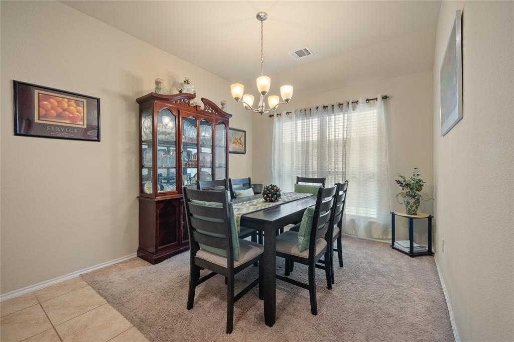 520 Rustic Oak Lane McKinney, TX 75072 - Photo 7 of 30 Dining area featuring a contemporary five-light chandelier, a large window with white blinds, and neutral-toned wall paint