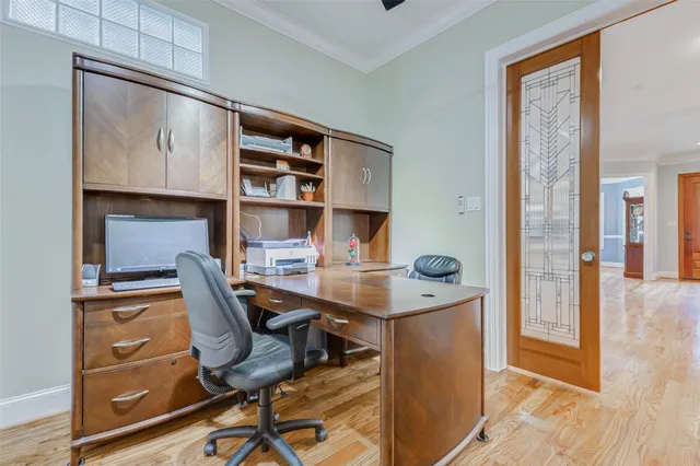 a view of a workspace with furniture and wooden floor