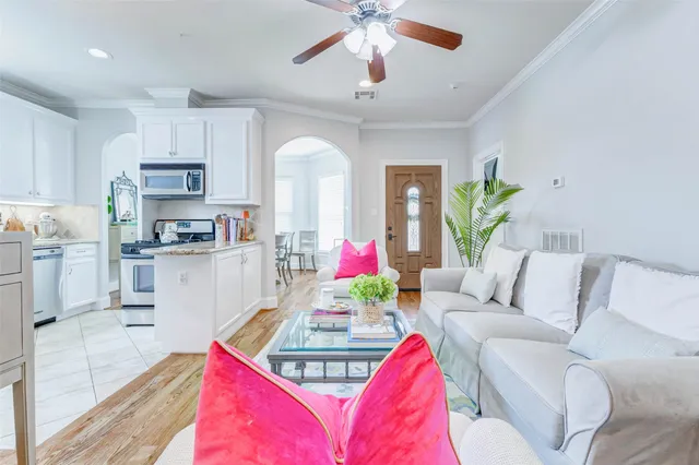 a living room with furniture and a chandelier