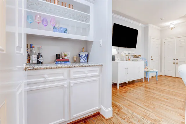 a living room with flat screen tv and dresser