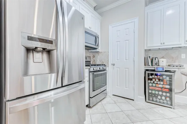 a kitchen with stainless steel appliances a refrigerator and a stove top oven