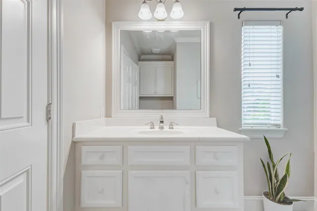 a bathroom with a sink a mirror and a window