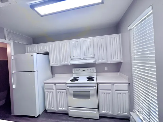 a white refrigerator freezer sitting inside of a kitchen