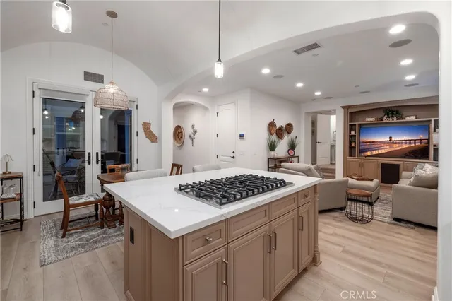 a view of kitchen island with stainless steel appliances granite countertop lots of counter top and stove