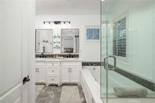 a bathroom with a tub sink and mirror