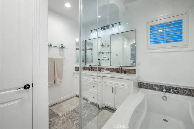 a spacious bathroom with a shower sink and mirror