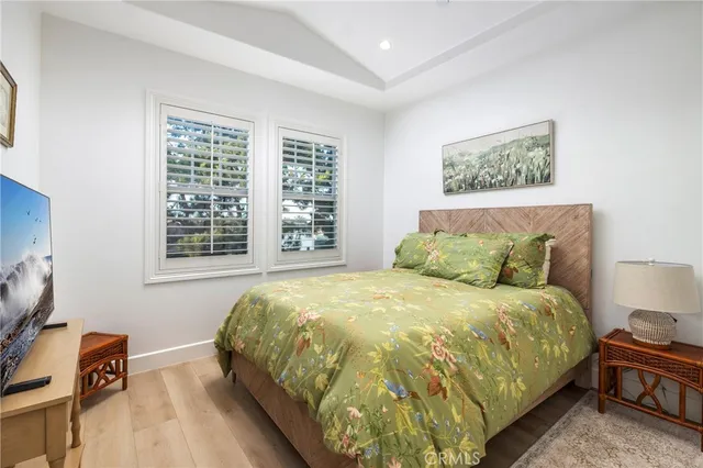 a large bed sitting in a bedroom next to a window