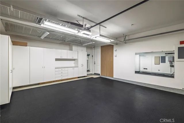 an empty room with a wooden floor and windows