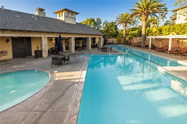 a view of a house with pool and sitting area