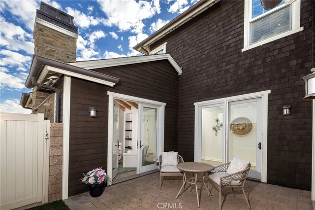 a view of a house with a chairs and table in a patio