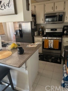 1111 Valley Spring Lane Colton, CA 92324 - Photo 1 of 2 a kitchen with stainless steel appliances granite countertop a sink stove and microwave