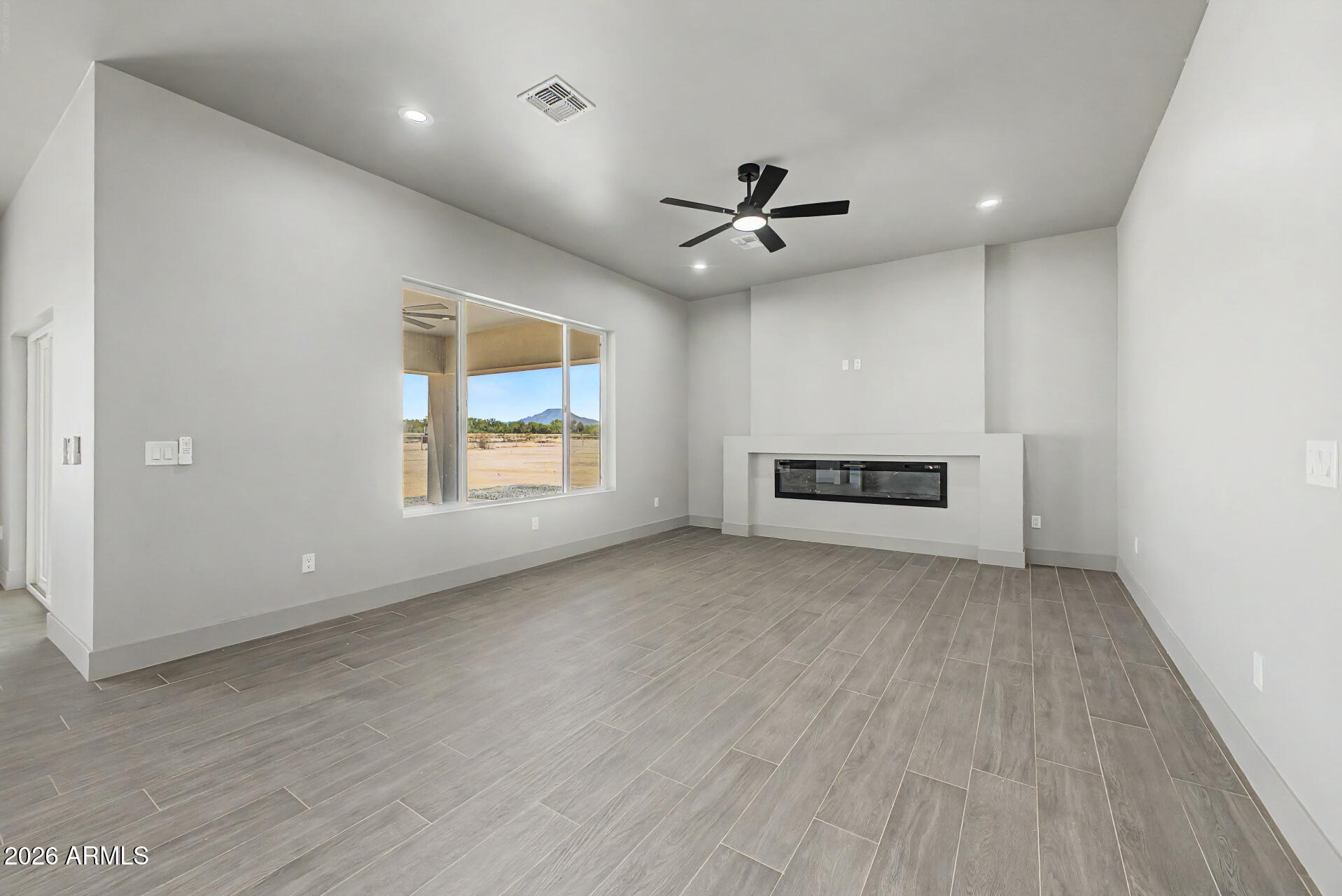 40461 West Robles Road Stanfield, AZ 85172 - Photo 21 of 54 an empty room with windows and ceiling fan