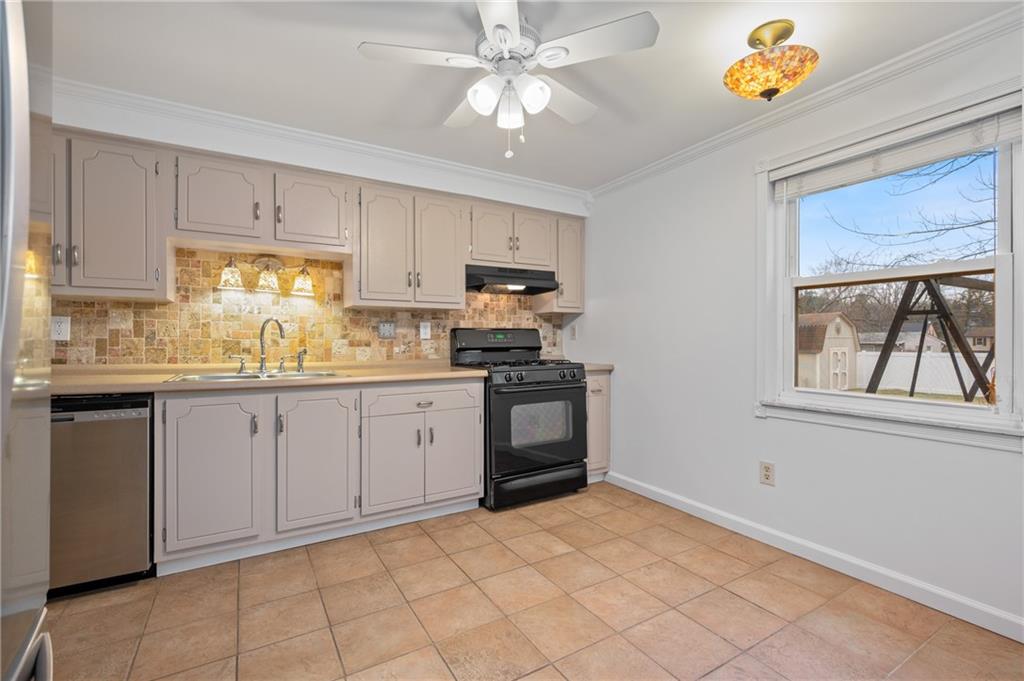 7 Dover Road Irwin, PA 15642 - Photo 11 of 31 a kitchen with a stove a sink and a refrigerator