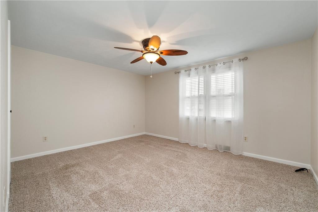 7 Dover Road Irwin, PA 15642 - Photo 14 of 31 an empty room with windows and chandelier fan