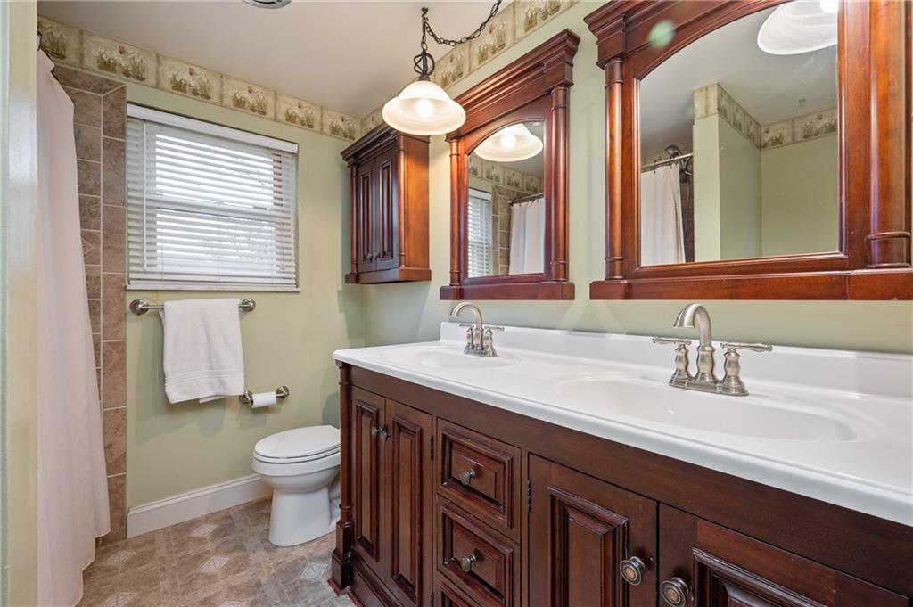 7 Dover Road Irwin, PA 15642 - Photo 18 of 31 a bathroom with a granite countertop sink a toilet and a mirror