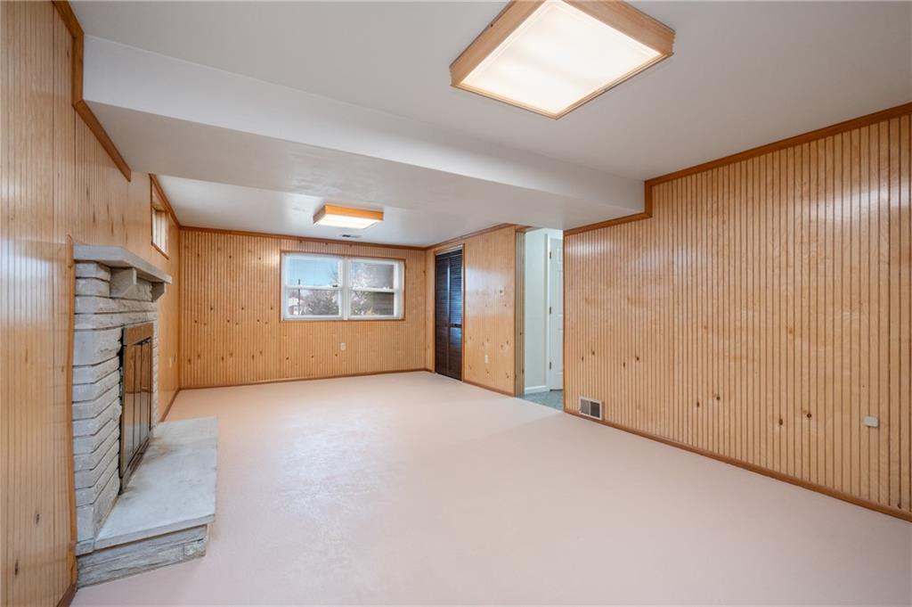 7 Dover Road Irwin, PA 15642 - Photo 19 of 31 an empty room with a fireplace and windows