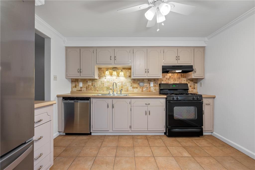 7 Dover Road Irwin, PA 15642 - Photo 9 of 31 a kitchen with a sink a stove and cabinets